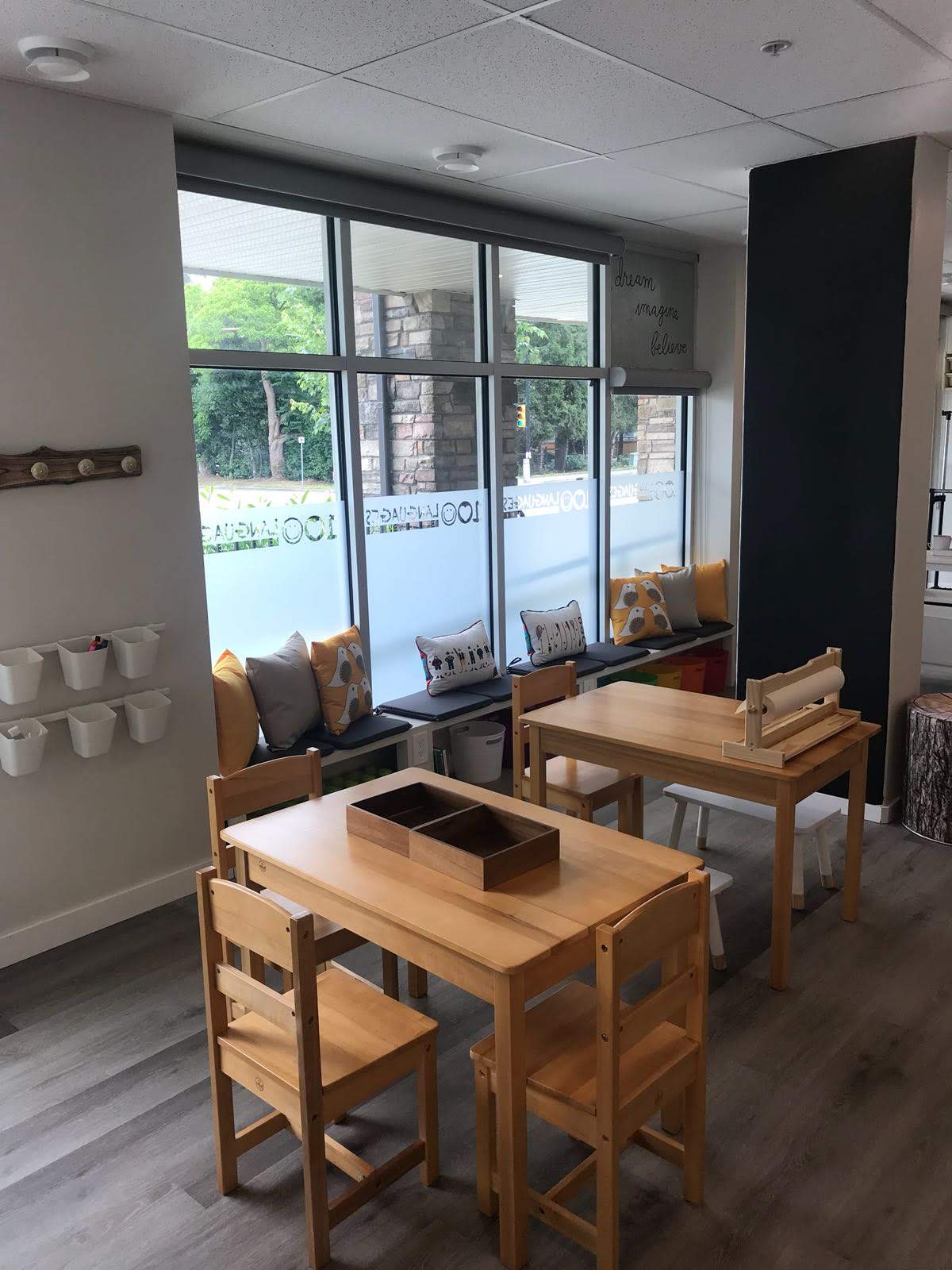 Bright Reggio Emilia classroom with wooden tables at Hundred Languages Child Care in Pitt Meadows BC